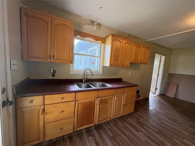 215 Fair Park St, Riesel, TX 76682 - kitchen featuring a sink, dark countertops, and dark wood-type flooring