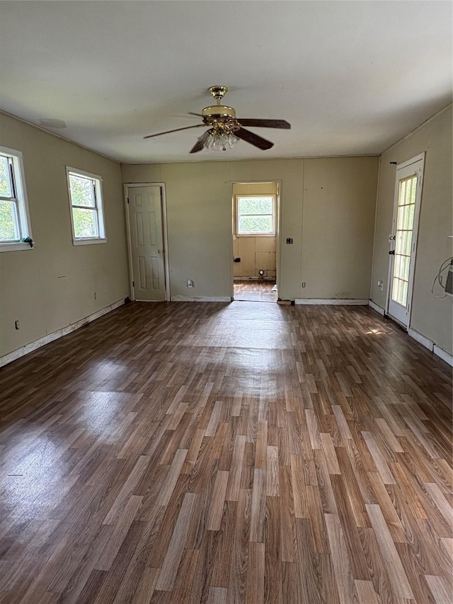 215 Fair Park St, Riesel, TX 76682 - unfurnished living room featuring wood finished floors, ceiling fan, and baseboards