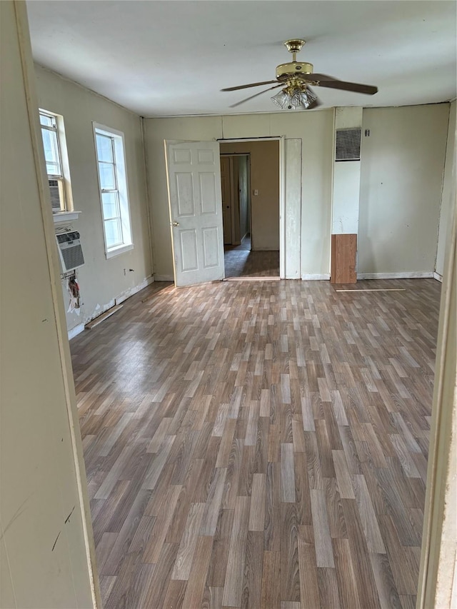 215 Fair Park St, Riesel, TX 76682 - unfurnished living room with wood finished floors, a ceiling fan, and baseboards