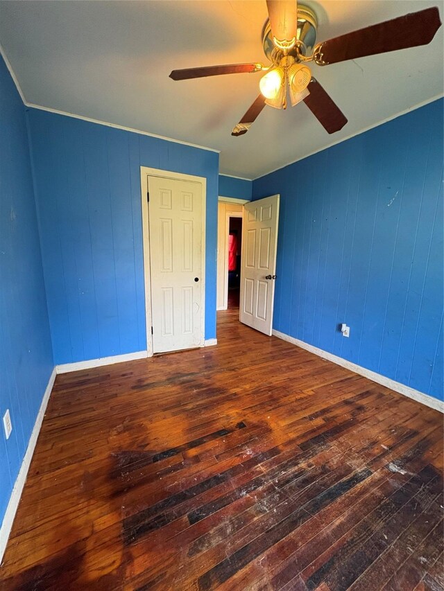 215 Fair Park St, Riesel, TX 76682 - unfurnished bedroom with hardwood / wood-style flooring, baseboards, and ceiling fan