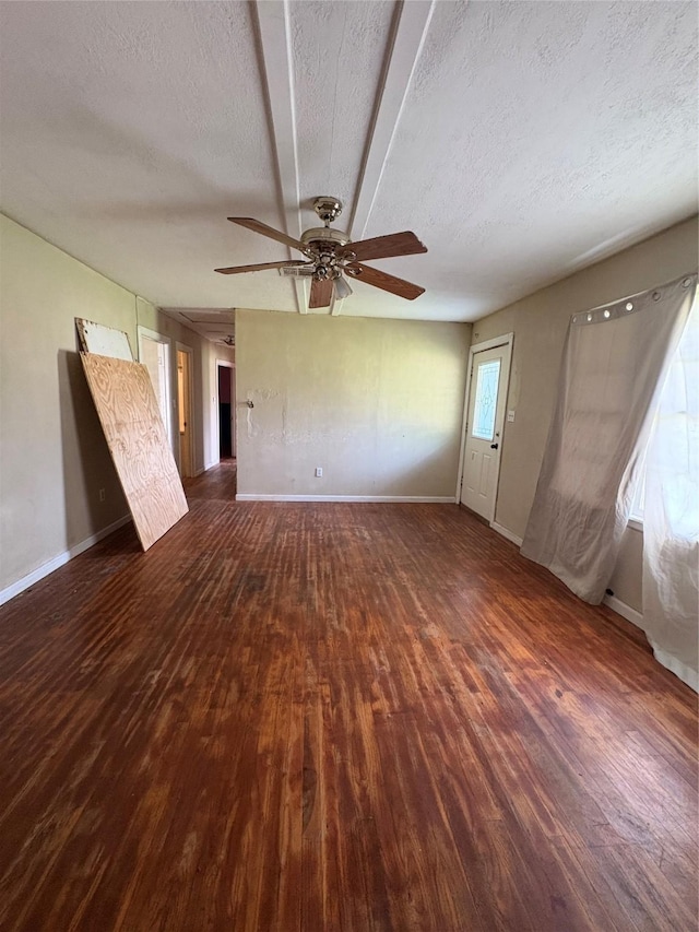 215 Fair Park St, Riesel, TX 76682 - unfurnished living room with wood finished floors, a textured ceiling, ceiling fan, and baseboards