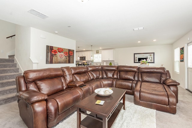 living room with light carpet, stairs, visible vents, and recessed lighting