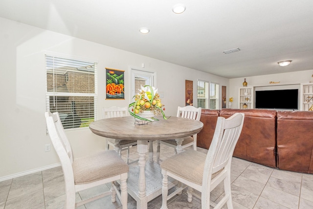 dining area with visible vents and light tile patterned floors