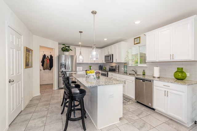 kitchen with stainless steel appliances, white cabinetry, and tasteful backsplash