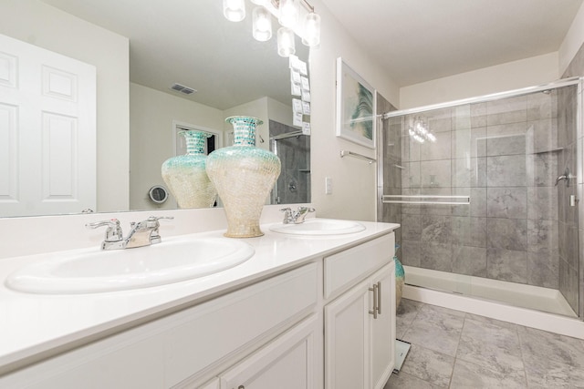 bathroom with visible vents, a sink, a shower stall, and double vanity