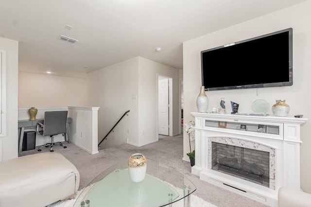living room with light carpet, visible vents, and baseboards