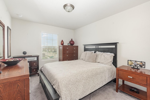 bedroom featuring light carpet