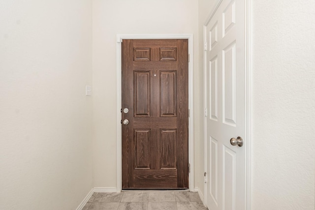 doorway to outside with baseboards