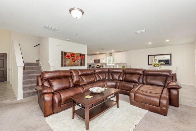 living room with light carpet, visible vents, recessed lighting, and stairs