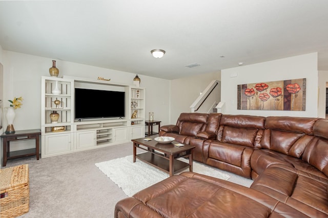 living area featuring carpet floors and visible vents