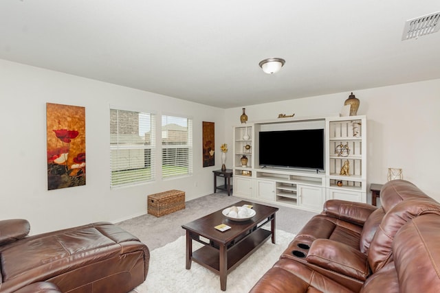 living room with light carpet, visible vents, and baseboards