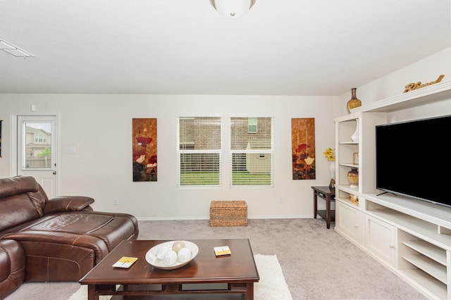 living room with visible vents, light carpet, and baseboards