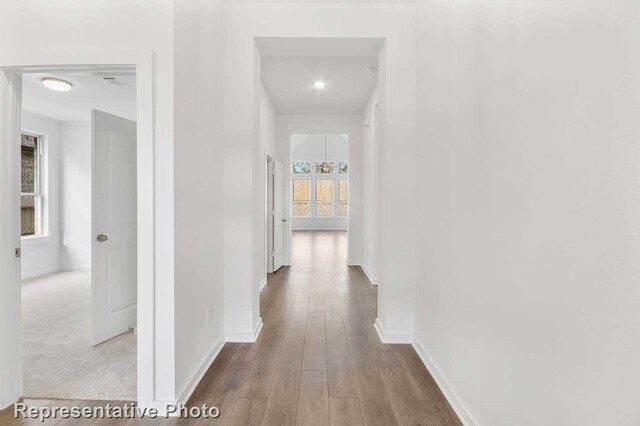 3705 Hickory St, Sherman, TX 75092 - hall with visible vents, wood finished floors, and baseboards