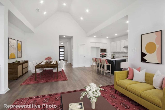 3705 Hickory St, Sherman, TX 75092 - living room with high vaulted ceiling, wood finished floors, visible vents, and recessed lighting