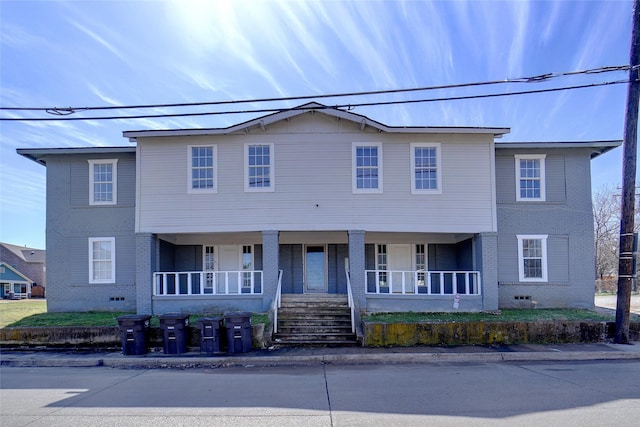 multi unit property with brick siding and covered porch