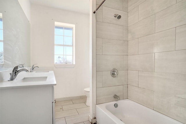 full bath with tile patterned floors, a sink, double vanity, toilet, and shower / bath combination