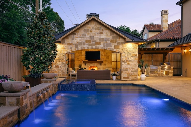 6511 Mimosa Ln, Dallas, TX 75230 - view of swimming pool with an outdoor stone fireplace, a patio, and a pool with connected hot tub
