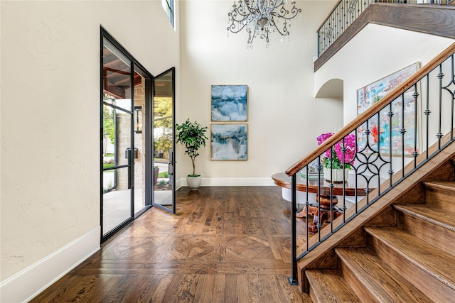 6511 Mimosa Ln, Dallas, TX 75230 - foyer featuring baseboards, a chandelier, stairway, and a towering ceiling