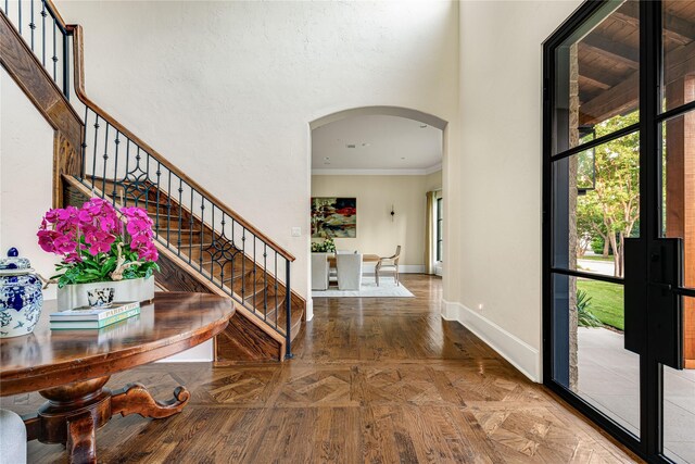 6511 Mimosa Ln, Dallas, TX 75230 - entryway with arched walkways, ornamental molding, baseboards, and stairway