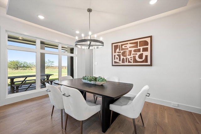dining space featuring recessed lighting, wood finished floors, baseboards, and a notable chandelier