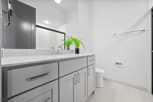 bathroom with recessed lighting, toilet, vanity, baseboards, and a stall shower