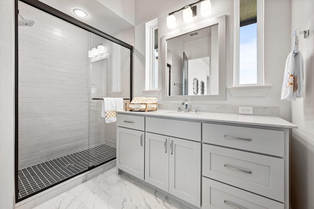 full bathroom featuring a shower stall, marble finish floor, and vanity