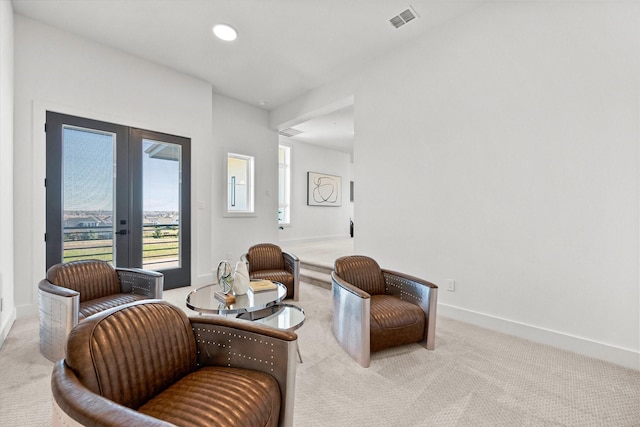 sitting room featuring visible vents, baseboards, french doors, and carpet flooring
