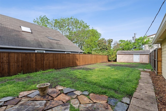 view of yard featuring a fenced backyard and an outdoor structure