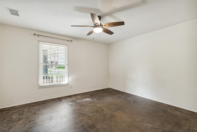 spare room featuring baseboards, a ceiling fan, and visible vents