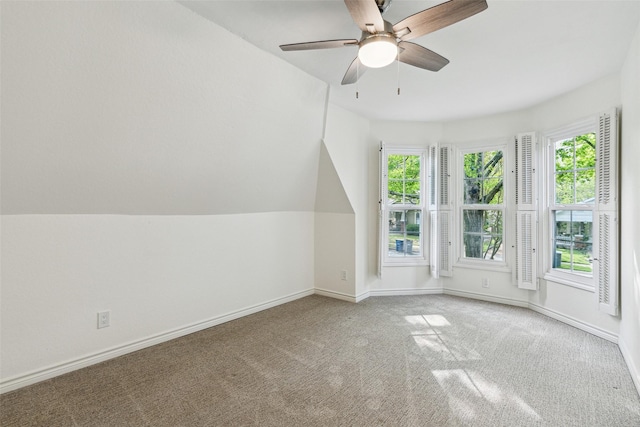 additional living space with baseboards, a ceiling fan, carpet flooring, and a wealth of natural light