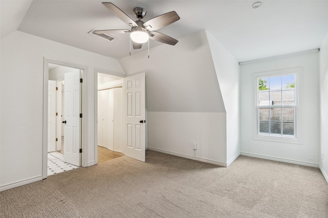 bonus room featuring carpet, vaulted ceiling, visible vents, baseboards, and ceiling fan