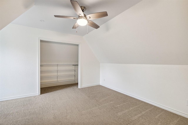 additional living space featuring vaulted ceiling, carpet flooring, baseboards, and a ceiling fan