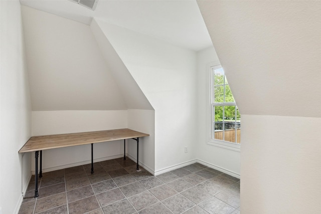 additional living space featuring vaulted ceiling, visible vents, and baseboards