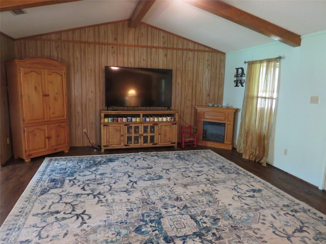 living area featuring lofted ceiling with beams, wooden walls, and dark wood finished floors