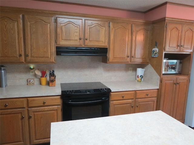 kitchen with decorative backsplash, stainless steel microwave, black / electric stove, light countertops, and range hood