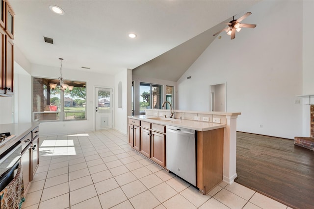 1371 Meadows Ave, Lantana, TX 76226 - kitchen featuring stainless steel dishwasher, a sink, a chandelier, light countertops, and light tile patterned floors