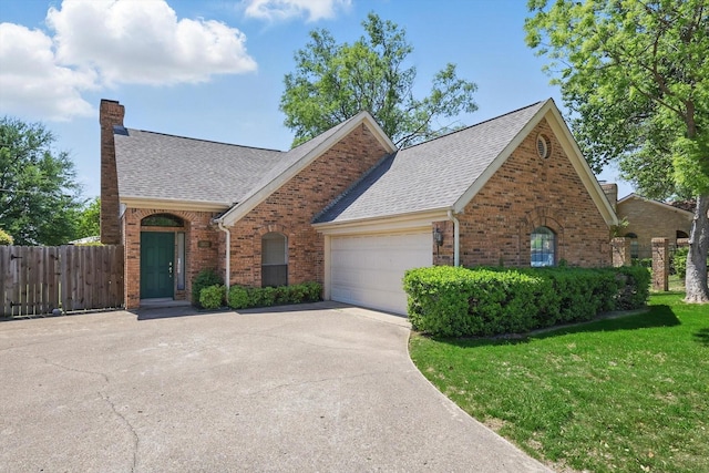 view of front facade with a garage, roof with shingles, brick siding, and driveway