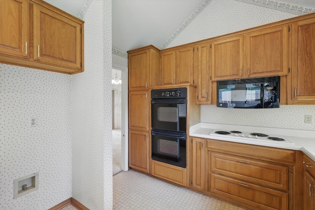 kitchen with light countertops, wallpapered walls, brown cabinets, and black appliances