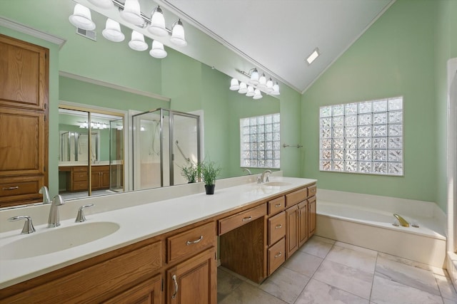 bathroom with double vanity, a shower stall, a garden tub, and a sink