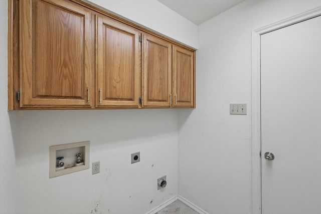 laundry area with hookup for an electric dryer, cabinet space, hookup for a washing machine, and baseboards