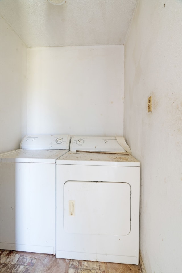 laundry area featuring washing machine and clothes dryer and laundry area