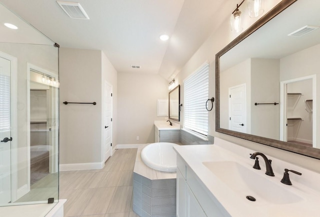 bathroom featuring a shower stall, visible vents, a garden tub, and a sink