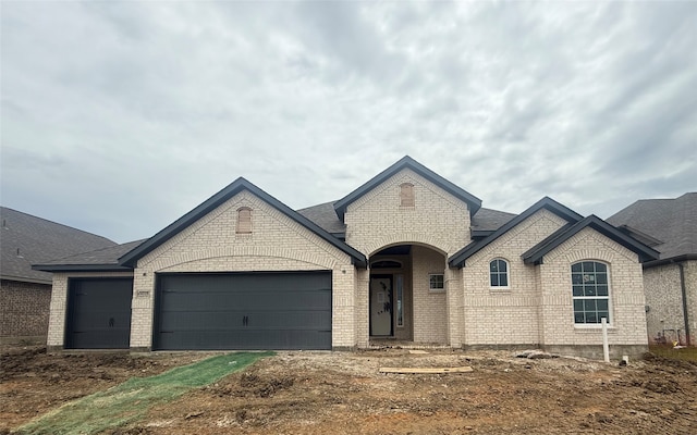 4225 Equine Dr, Joshua, TX 76058 - french country style house with a garage, brick siding, and a shingled roof
