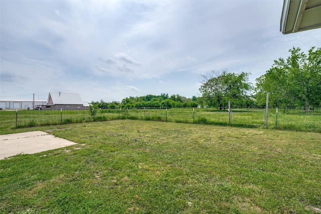 view of yard with a rural view and fence