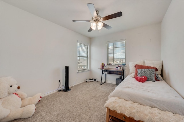 bedroom with a ceiling fan, baseboards, and light carpet