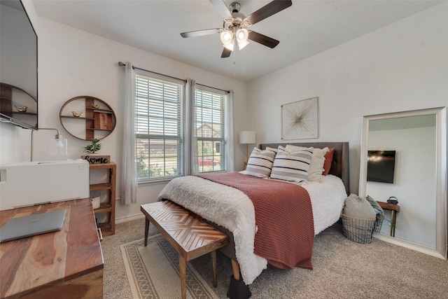 carpeted bedroom featuring baseboards and a ceiling fan