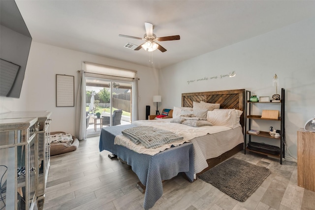 bedroom featuring visible vents, a ceiling fan, light wood-style floors, and access to exterior
