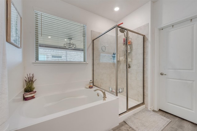 bathroom featuring a garden tub and a stall shower
