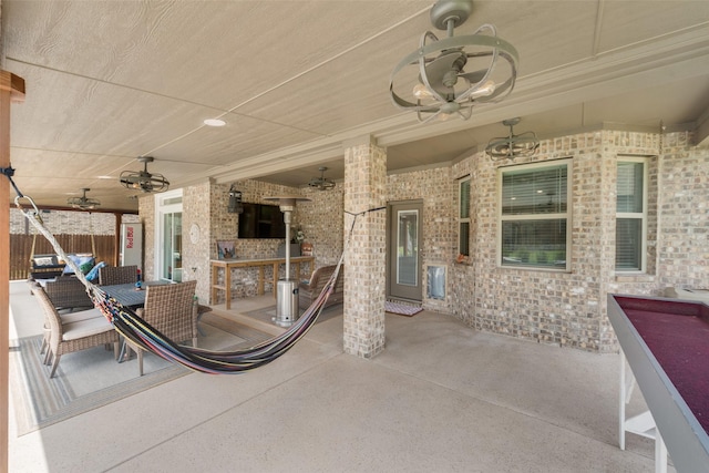 view of patio / terrace with a ceiling fan and fence