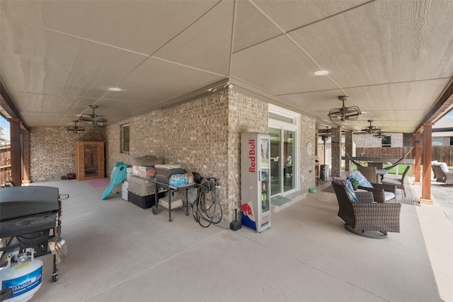 view of patio featuring fence and a ceiling fan